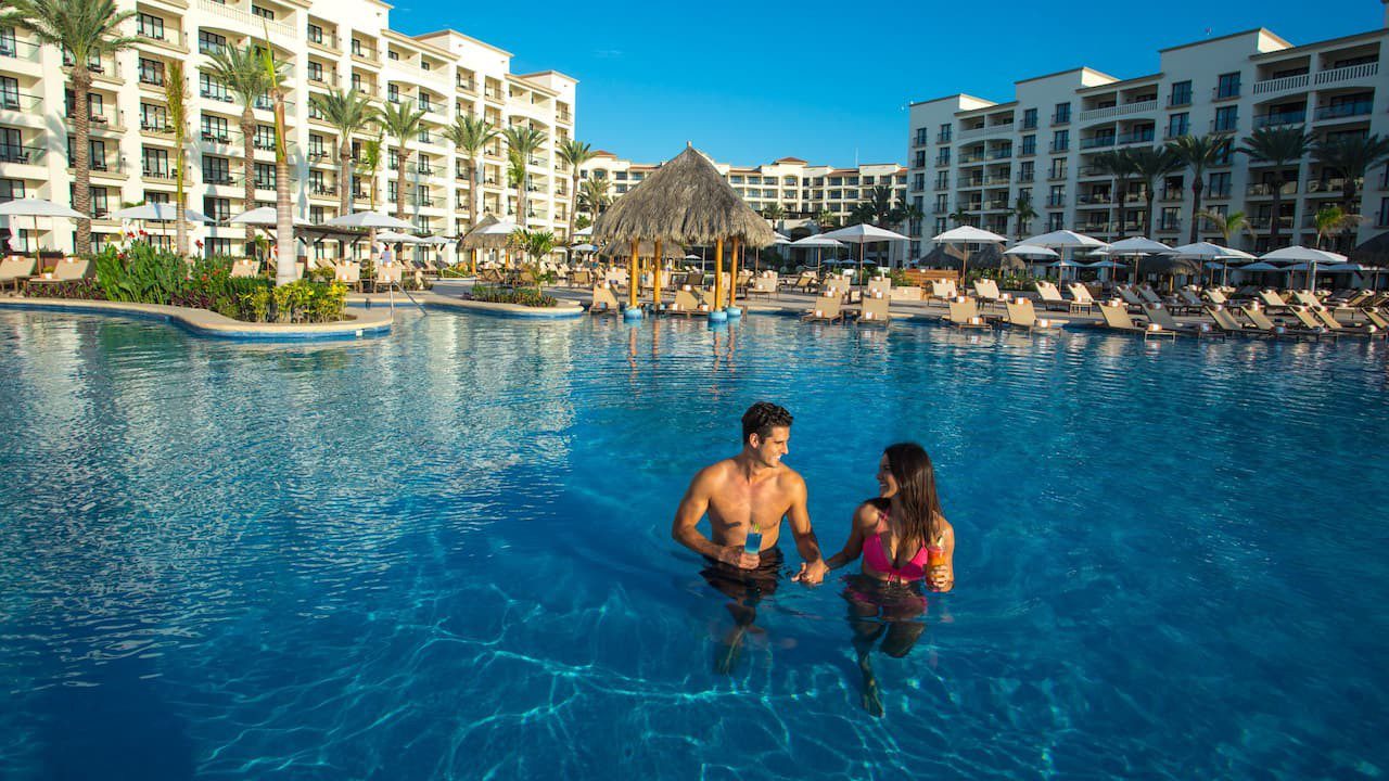 Hyatt-Ziva-Los-Cabos-P161-Couple-Walking-Down-Infinity-Pool.16x9